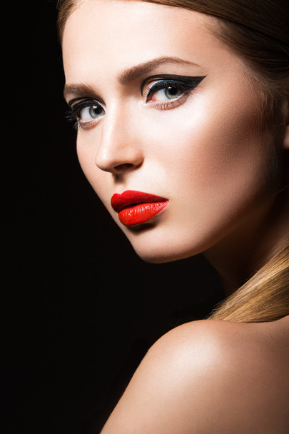 Beautiful girl with unusual black arrows on eyes and red lips. Beauty face. - Fotografie, Obrázek