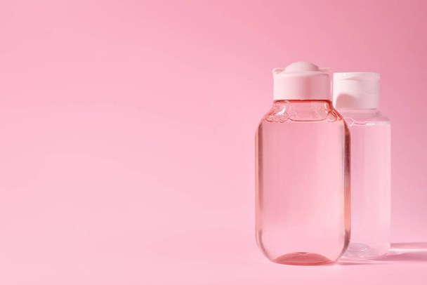 Bottles of micellar water on pink background. Space for text - 写真・画像