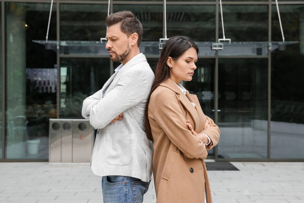 Upset arguing couple near building outdoors. Relationship problems - Photo, image