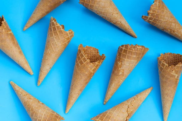 Empty ice cream cone on blue background. - Photo, Image