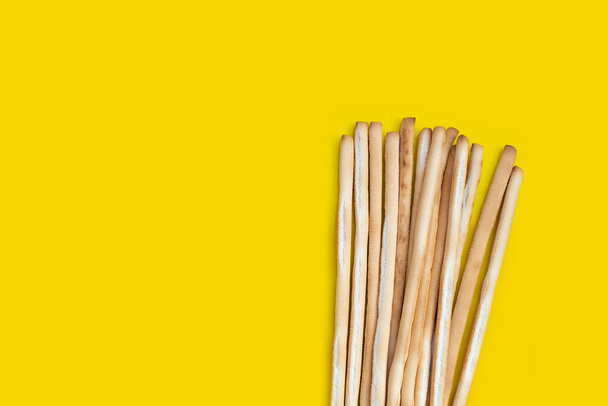 Bread sticks on yellow background - Photo, Image