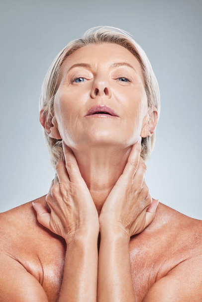 Face, skincare and beauty with a senior woman in studio on a gray background for wellness or natural treatment. Portrait, skin and luxury with a mature female posing to promote a cosmetic product. - Fotó, kép