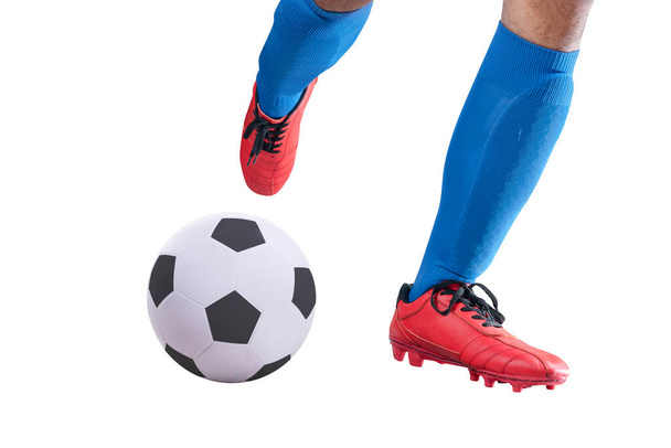 Football player man in a blue jersey kicking the ball posing isolated over white background - Photo, image