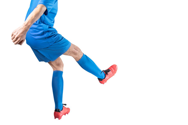 Football player man in a blue jersey with the pose of kicking the ball isolated over white background - Fotoğraf, Görsel