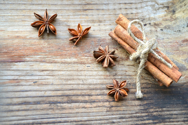 Cinnamon sticks and spicy anise stars on wooden table - Photo, Image