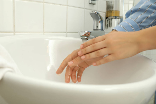 Woman clean hands in wash basin, close up - 写真・画像