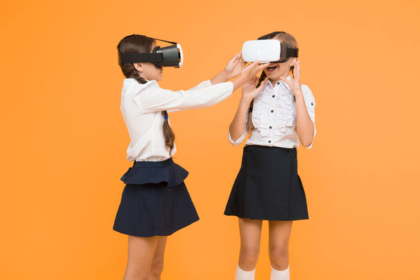 Experiences communicate and manage projects.Kids use modern VR technology. Virtual reality. VR headset. Future education. Children schoolgirls wear wireless VR glasses. Exploring augmented reality. - Фото, зображення