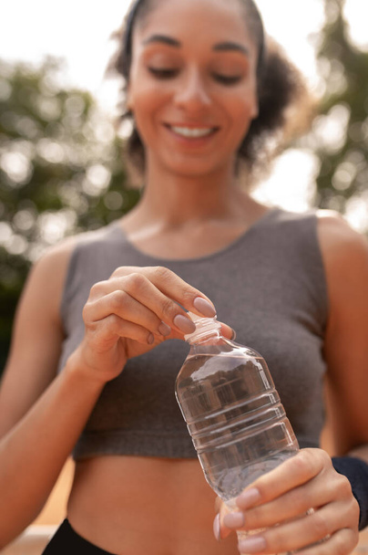 Water balance. Cute young girl feeling thirsty after workout - 写真・画像