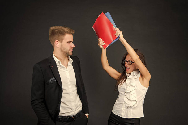 Conflict in the professional workplace. Aggressive woman hit man with books. Conflict management. Coworkers fighting. Workplace fight. - Foto, imagen