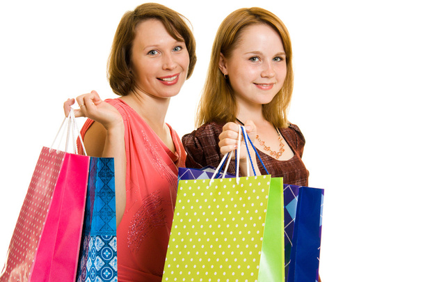 Girls with shopping on white background. - Foto, Imagen