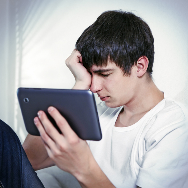 Sad Young Man with Tablet - 写真・画像