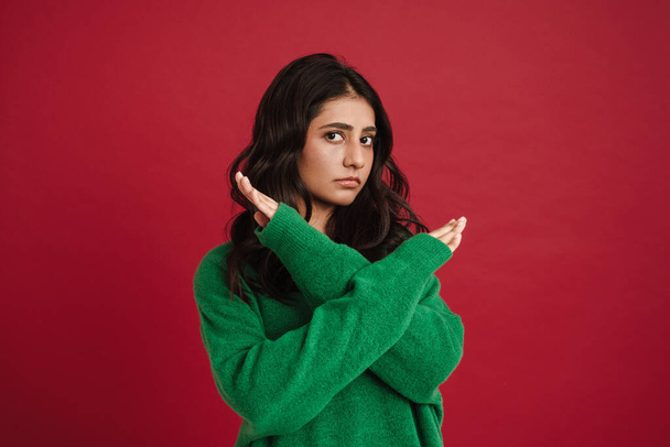 East asian woman wearing sweater showing stop gesture isolated over red background - Valokuva, kuva