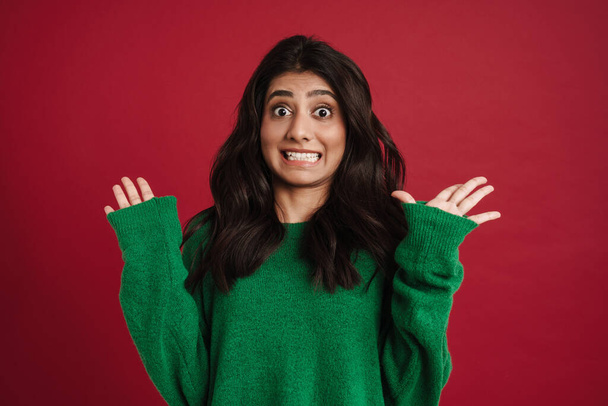 East asian woman wearing sweater smiling and showing ok sing isolated over red background - Fotó, kép