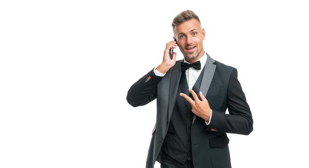 amazed gentleman in tuxedo speak on phone isolated on white background with peace gesture. - Foto, immagini