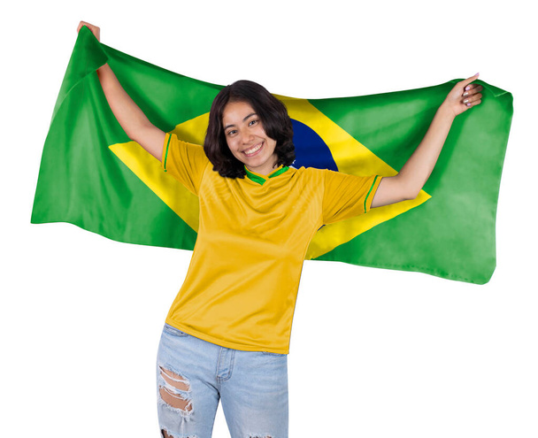 Young soccer fanatic woman with yellow sports jersey and flag to Brazil in his hands, happy for the victory of his favorite team. - Valokuva, kuva
