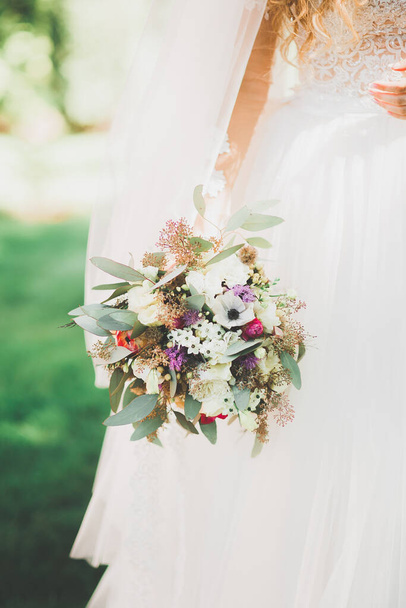 Bride holding big and beautiful wedding bouquet with flowers. - Foto, immagini