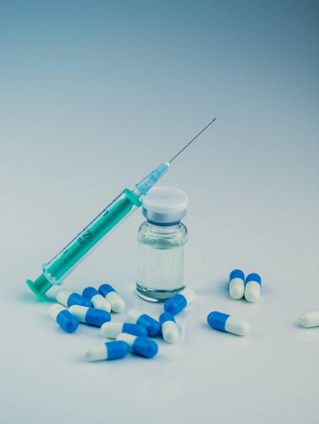 syringe with needle, vial and pills with steroids. illegal doping in sport concept - 写真・画像