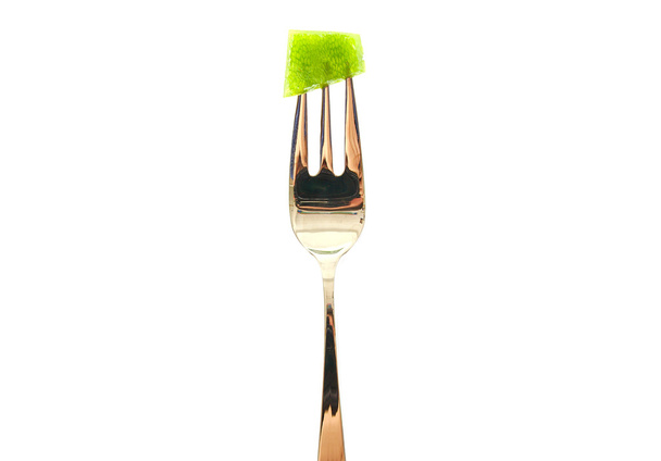 Fork with a green pepper slice isolated on white background. - Foto, immagini