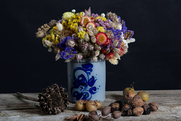 Bouquet beautiful dried flowers in a vintage vase. High quality photo - Photo, Image
