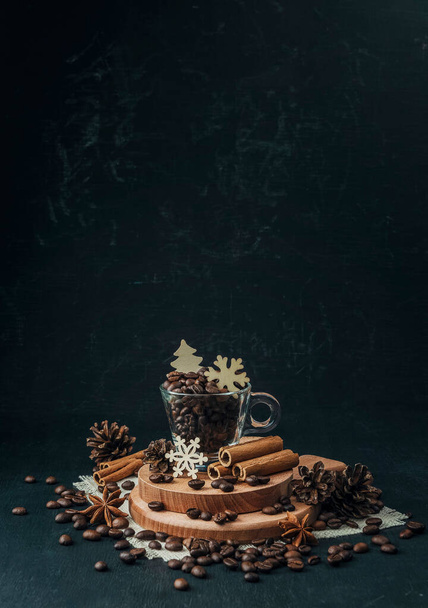 The concept of coffee drinks. Winter holidays concept with favorite coffee. Coffee beans and handmade wooden figurines with a winter themed. Winter coziness. Christmas is coming. - Foto, Imagem