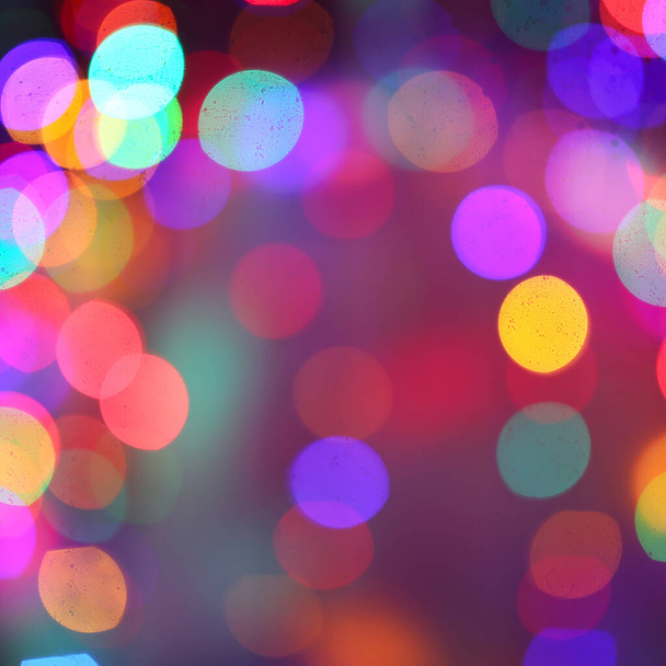 Large Blurred Christmas Lights are Illuminated to create an abstract colorful rainbow bokeh square background display - Фото, изображение