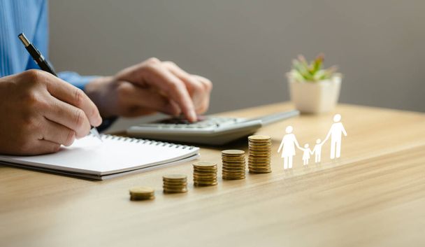 Family finance plan concept, businessman putting coin and icon family on table, donation, saving, charity, fundraising, superannuation, investment, fund, financial crisis concept. - Photo, Image