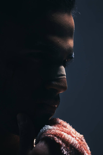 Dark, man and face of warrior thinking or ready for war, battle or ring match against a mockup background. Closeup of male fitness boxer with bloody hand in thought for sports fight or game plan. - Foto, afbeelding