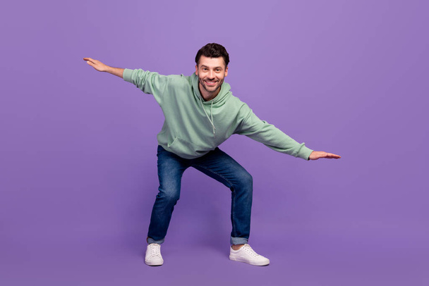 Full body size photo of cheerful positive millennial man wear stylish outfit clothes summer sale shopping offer balance isolated on violet color background. - Fotoğraf, Görsel