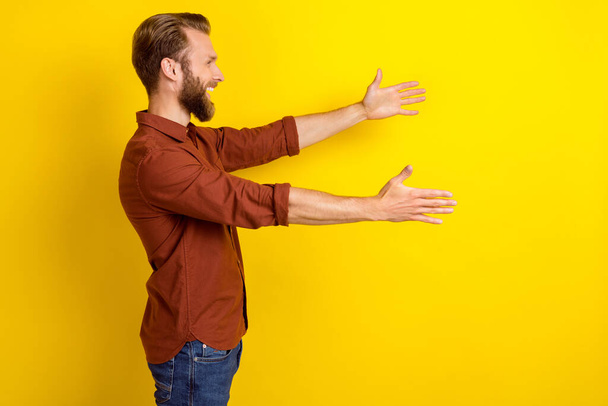 Profile side photo of positive men open hand arm hurry hug friend welcome come here look empty space isolated on yellow color background. - Φωτογραφία, εικόνα