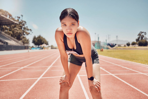 Runner, race track and woman in portrait for competition training, running event or marathon at a stadium on blue sky mock up. Focus, motivation and tired athlete girl with fitness and workout race. - Fotoğraf, Görsel