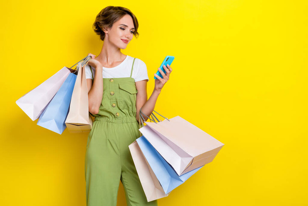 Photo of millennial hipster woman hold smartphone just take package gift eshopping free delivery ebay mockup isolated on yellow color background. - Photo, Image
