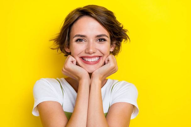 Photo of adorable gorgeous girl with bob hairstyle wear white t-shirt arms on cheekbones dental ad isolated on yellow color background. - 写真・画像