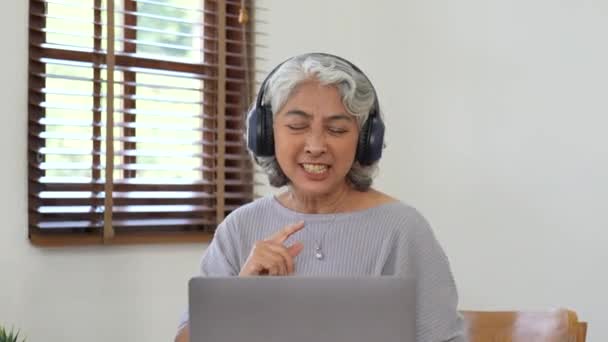 Üst düzey kadın ailesiyle iletişim kuran dizüstü bilgisayara bak. Yaşlı kadın video araması için laptop kullanıyor. - Video, Çekim