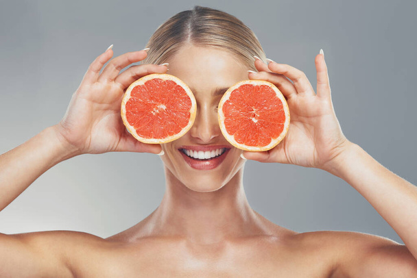 Woman, beauty and product with grapefruit skincare for healthy skin, self care and natural cosmetics glow. Facial citrus moisturizer, happy face and moisturizing vitamin c organic cosmetology routine. - Fotografie, Obrázek