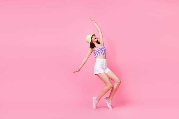 Full body photo of pretty excited girl enjoy partying dancing good mood isolated on pink color background. - Foto, Imagem