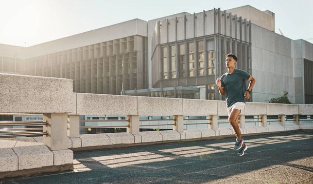 Man, running or city street or road fitness for cardio exercise, wellness training or marathon workout. Runner, sports athlete or personal trainer and running shoes, speed energy or health motivation. - 写真・画像