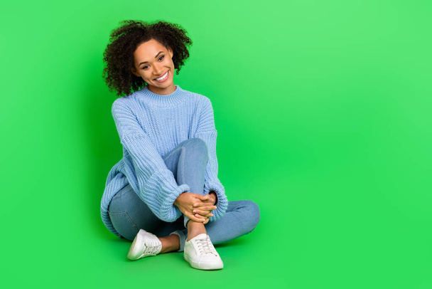 Full size photo of charming cheerful lady sit floor have good mood empty space isolated on green color background. - Foto, immagini