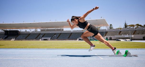 Fitness, start and running with woman in stadium for sports, training and marathon on race track. Fast, action and cardio with runner of competition field for speed, energy and endurance performance. - Fotoğraf, Görsel