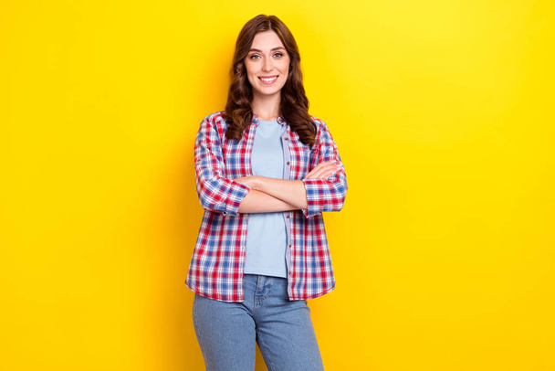 Photo of pretty confident girl dressed checkered shirt smiling arms crossed isolated yellow color background. - Фото, изображение