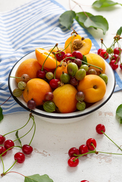 Summer fruits in white bowl pie concept cherry apricots berry close up food - Valokuva, kuva