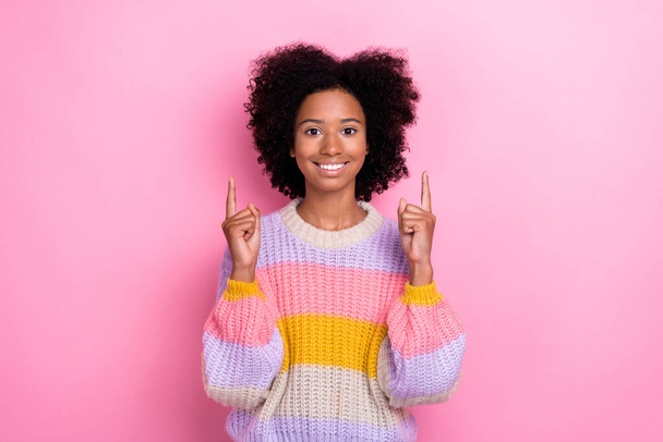 Photo of toothy beaming positive girl with perming coiffure wear knit sweater directing empty space isolated on pink color background. - Φωτογραφία, εικόνα