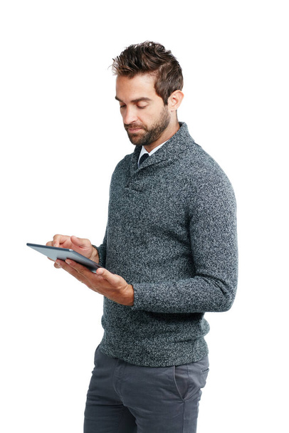 Connectivity and productivity go hand in hand. Studio shot of a handsome businessman using a digital tablet against a white background - Photo, Image