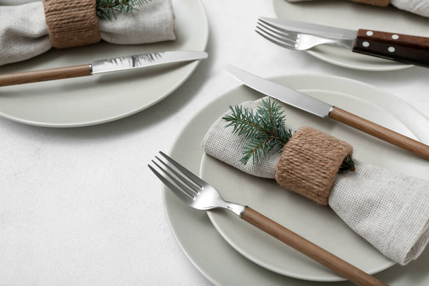 Beautiful table setting with Christmas branches on white background, closeup - 写真・画像