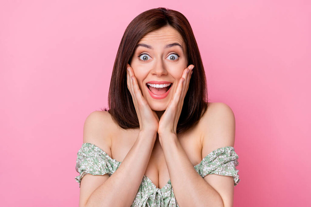Photo of astonished positive pretty lady wonder good news information arm palm touch cheekbones isolated on pink color background. - Photo, Image