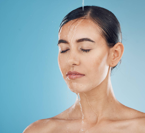 Water splash, woman face and beauty of a model in shower relax about skin wellness, health and care. Cosmetic, clean and healthy body skincare of a young person calm after luxury spa treatment. - Photo, Image