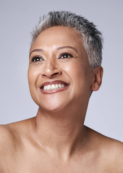 Mature woman, face or skincare glow on studio background or gray hair, health wellness or makeup cosmetics. Smile, happy or Indian beauty model or facial texture, dermatology or collagen in self love. - Foto, Imagem