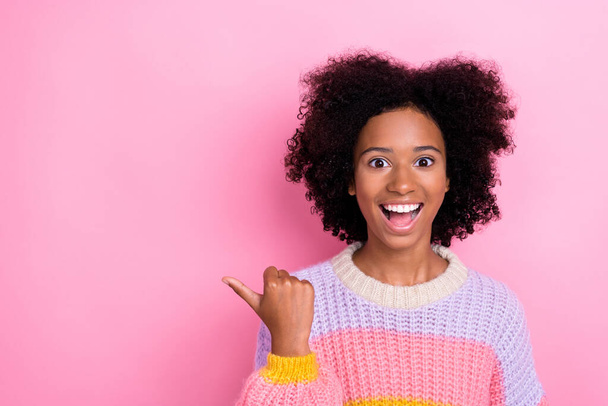 Photo of impressed excited ecstatic girl perming coiffure wear knit sweater indicating empty space isolated on pink color background. - Zdjęcie, obraz