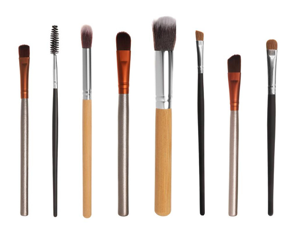 Set with different makeup brushes for applying cosmetic products on white background - 写真・画像