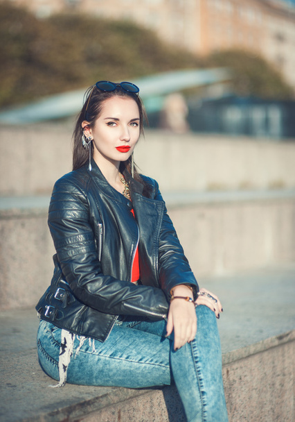 Young fashion beautiful girl in leather jacket and sunglasses - 写真・画像