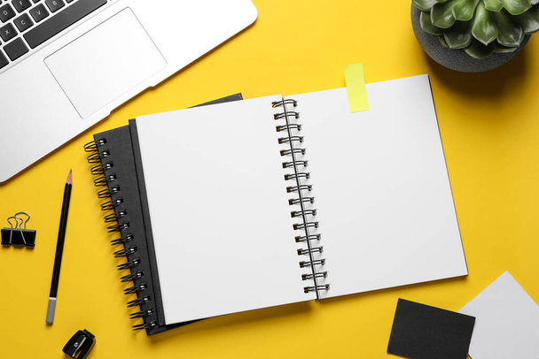 Flat lay composition with stylish notebooks on yellow background - Foto, imagen